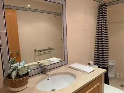 a bathroom with a sink and a large mirror at Kasa Joly Albufeira By Calyferias in Albufeira