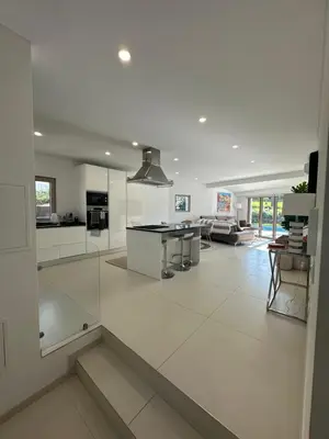 a large kitchen and living room with white walls at Vila Golf in Vilamoura