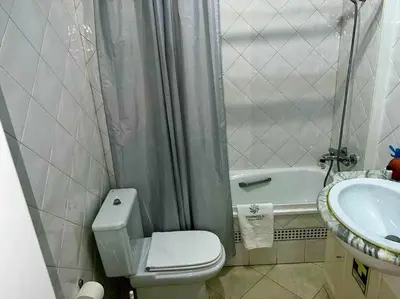 a small bathroom with a toilet and a sink at Infante Sagres by FHR1º linha da praia in Quarteira