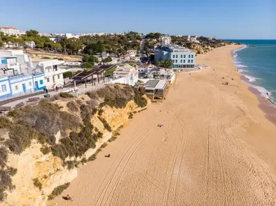 an aerial view of a beach with houses and the ocean at Refurbished beachfront house, Pool, AC, WiFi, Albufeira, sea view in Albufeira