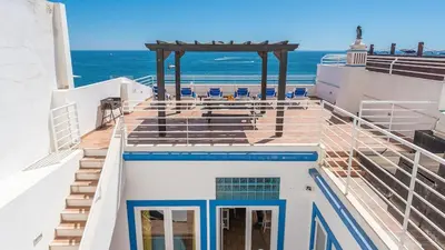 a view of the ocean from the balcony of a cruise ship at Refurbished beachfront house, Pool, AC, WiFi, Albufeira, sea view in Albufeira