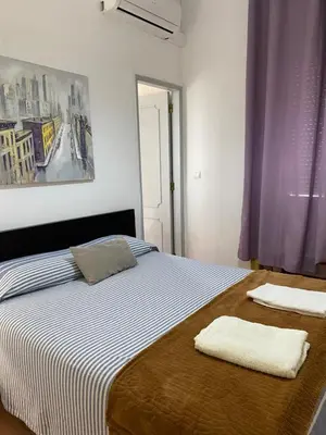 a bedroom with a bed with two towels on it at The Tiles House in Faro