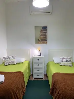 a bedroom with two beds and a white dresser at The Tiles House in Faro