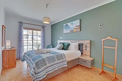 a bedroom with a large bed and a ladder at Villa Acoteias - By Dalma Portuguesa in Olhos de Água