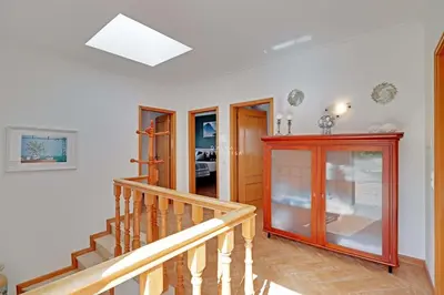 a room with a staircase and a red cabinet at Villa Acoteias - By Dalma Portuguesa in Olhos de Água
