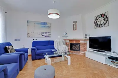 a living room with blue couches and a fireplace at Villa Acoteias - By Dalma Portuguesa in Olhos de Água