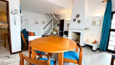 a dining room with a wooden table and chairs at Albufeira Calipto by Sunny Deluxe in Albufeira