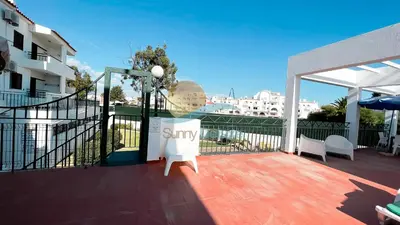 a balcony with a table and chairs on a building at Albufeira Calipto by Sunny Deluxe in Albufeira