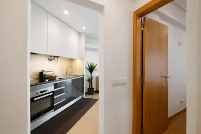 a bedroom with a large bed with two towels on it at Apartamento Peron in Quarteira