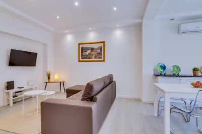 a living room with a couch and a table at Marina Star Guesthouse in Faro