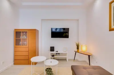 a living room with a couch and a table at Marina Star Guesthouse in Faro