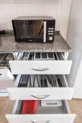 a microwave oven sitting on top of a kitchen counter at BeGuest Copacabana Vilamoura Apartment in Quarteira