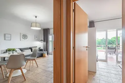 a living room and dining room with a table at BeGuest Copacabana Vilamoura Apartment in Quarteira