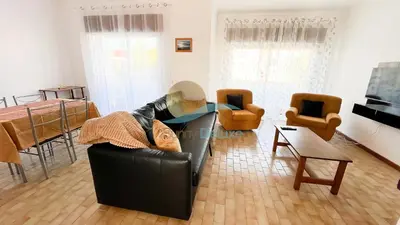a living room with a black leather couch and chairs at Apartamentos Oura AreiaSol by Sunny Deluxe in Albufeira
