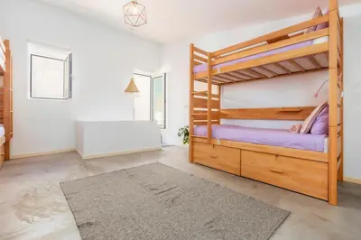 a bedroom with a bunk bed and a bathroom at Female Hostel in Faro