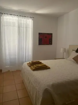 a bedroom with a bed with a robe on it at House of Rising Sun in Quarteira