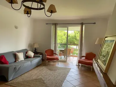 a living room with a couch and chairs and a table at House of Rising Sun in Quarteira