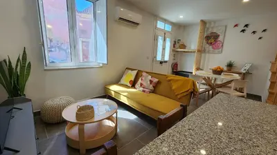 a living room with a couch and a table at Casa do Sol Faro in Faro