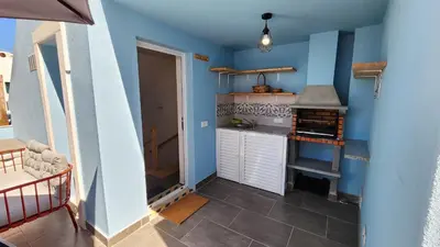 a small kitchen with a stove and blue walls at Casa do Sol Faro in Faro