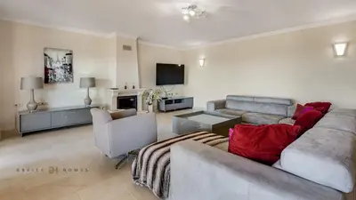 a living room with a couch and a tv at Luxuosa moradia V5 em Quarteira - Greice Homes in Quarteira