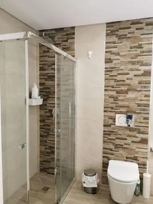 a bathroom with a toilet and a glass shower at Santa Fé in Albufeira