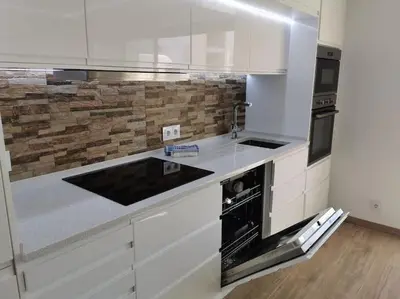 a white kitchen with a sink and a stove at Santa Fé in Albufeira