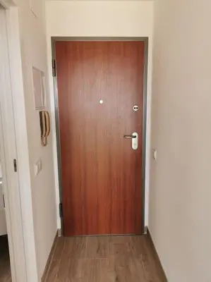 a wooden door in a hallway with a wooden floor at Santa Fé in Albufeira