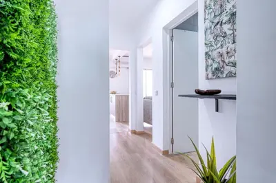 a hallway with a green wall in a house at Faro Center with AC & WiFi in Faro