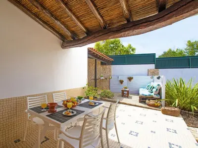 an outdoor patio with a table and chairs at Holiday Home Sebastião by Interhome in Paderne