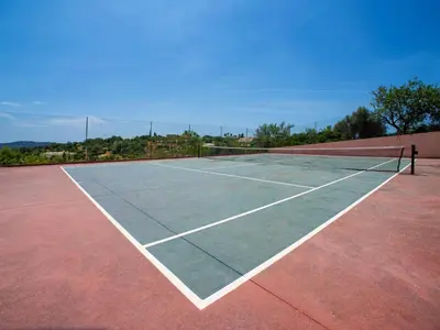 a tennis court with a net on top of it at Holiday Home Sebastião by Interhome in Paderne