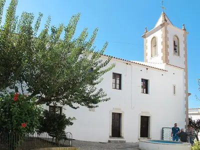 a white building with a tower and a church at Holiday Home Sebastião by Interhome in Paderne