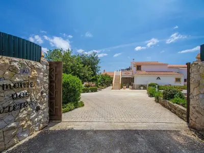 a patio with a fireplace and a swimming pool at Holiday Home Ana by Interhome in Paderne