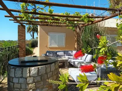 a patio with a fire pit in a yard at Casa de Apra by Portucasa in Loulé