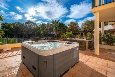a hot tub on the patio of a house at Place in the sun - Free out door Jacuzzi - BY BEDZY in Albufeira