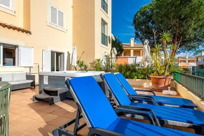 a group of blue lounge chairs on a patio at Place in the sun - Free out door Jacuzzi - BY BEDZY in Albufeira