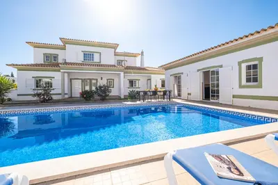 a villa with a swimming pool and a house at Villa Bahia by Algarve Vacation in Albufeira