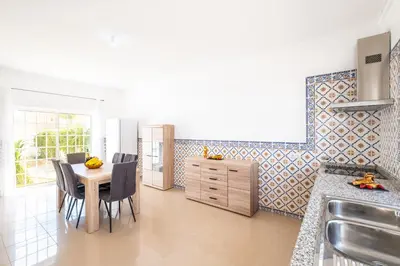 a kitchen with a table and chairs and a sink at Villa Bahia by Algarve Vacation in Albufeira