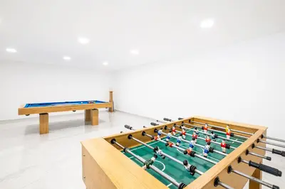 a large billiard table in a room with a bench at Villa Coral Bay by Algarve Vacation in Albufeira
