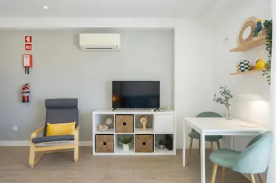 a bedroom with a bed and a balcony at Centralgarve - Stunning Beach Front Studio - Astro in Quarteira