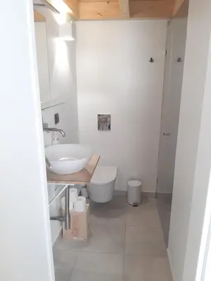 a white bathroom with a sink and a toilet at Casa aOrta Studios in Faro