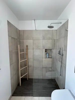 a bathroom with a shower with a glass door at Casa aOrta Studios in Faro