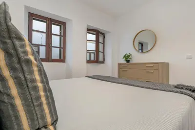 a bedroom with a bed and a dresser and a mirror at Casa dos Sonhos Albufeira in Albufeira