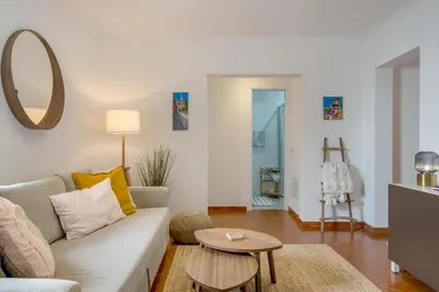 a living room with a couch and a table at Casa dos Sonhos Albufeira in Albufeira
