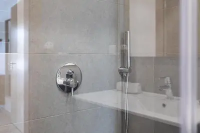 a shower in a bathroom with a glass door at Centralgarve - Beachfront with Pool Penthouse in Quarteira