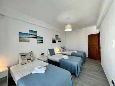two beds in a room with blue sheets at Albufeira Downtown With Pool by Homing in Albufeira