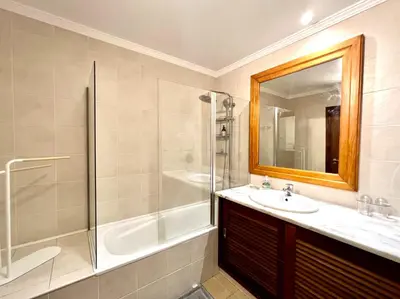 a bathroom with a shower and a sink and a mirror at Albufeira Salgados Beach 3 by Homing in Albufeira