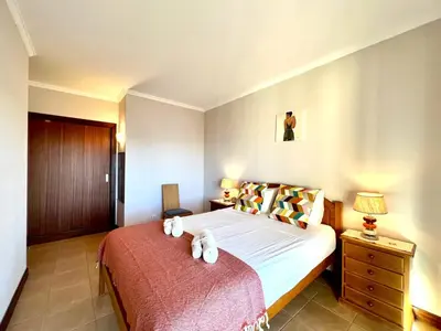 a bedroom with a bed with two towels on it at Albufeira Salgados Beach 3 by Homing in Albufeira