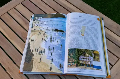 an open book on a table with a beach at ALEGRIA 29 - T2 piso terreo com AC e piscina by My Algarve Rentals in Quarteira