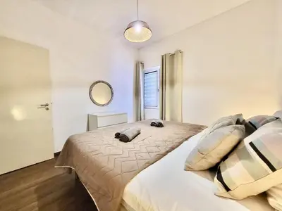 a bedroom with a bed with pillows on it at Vilamoura Central 4 With Pool by Homing in Vilamoura