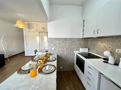 a kitchen with a table with plates of food on it at Vilamoura Central 4 With Pool by Homing in Vilamoura